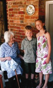 Daphne with great-grandchildren outside Cherrycroft